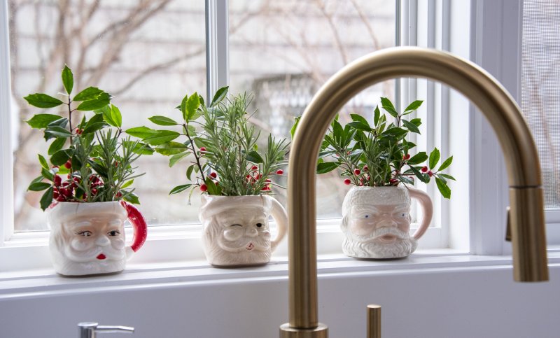 Santa cups filled with seasonal greenery sit in the window of the McCarthy home.